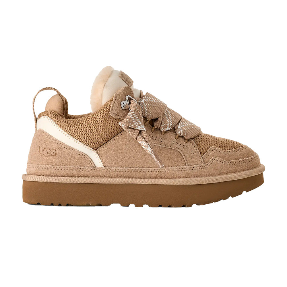 Sand UGG low-top sneaker, right foot view, suede and mesh, cream sole, decorative strap, UGG logo.