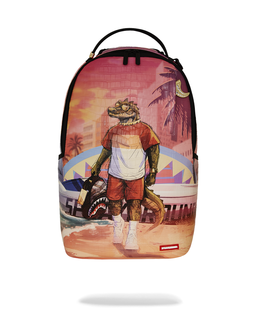 A colorful Sprayground backpack featuring a graphic of a cool, anthropomorphic alligator standing on a beach. The alligator is wearing a striped white and red shirt, red shorts, and sunglasses. He is holding a Sprayground backpack in one hand. In the background, a sunset with palm trees and a city skyline is visible. A surf van with a shark mouth design is parked behind him. The entire backpack has a subtle, croc-skin texture. The bottom of the bag has a small red tag with the Sprayground logo.