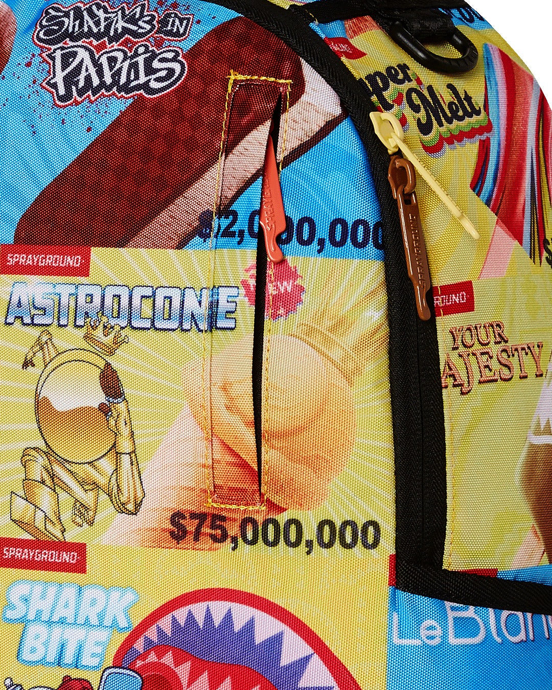 A close-up of a colorful Sprayground backpack with a cartoon ice cream menu graphic. The image shows a side pocket with an orange zipper pull and a larger main zipper with a brown pull. The graphic includes a character named "ASTROCONE," and a chocolate ice cream bar labeled "$2,000,000" at the top. The background is a bright yellow and light blue.
