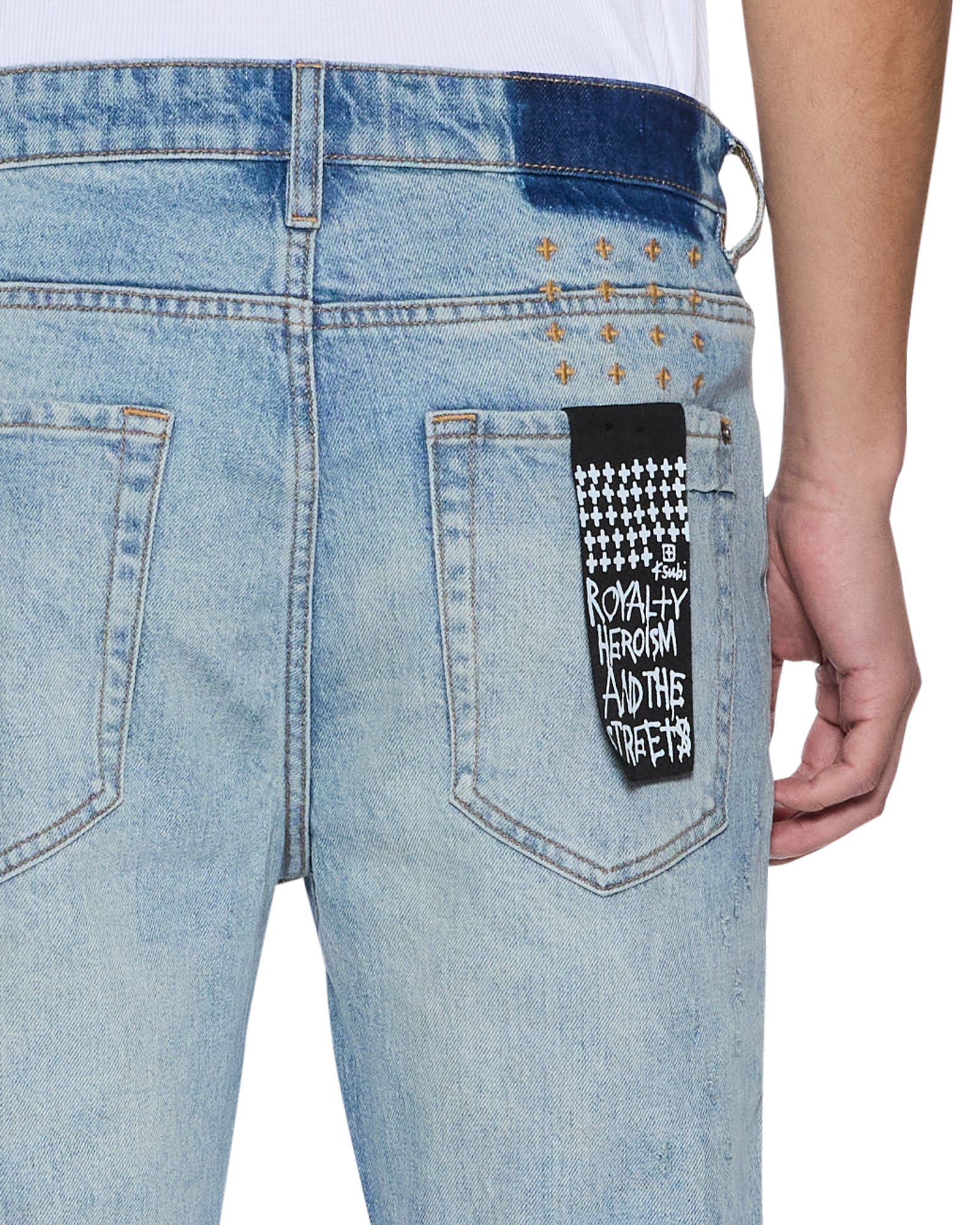 Light blue jeans with a patch on the pocket, worn by a person.