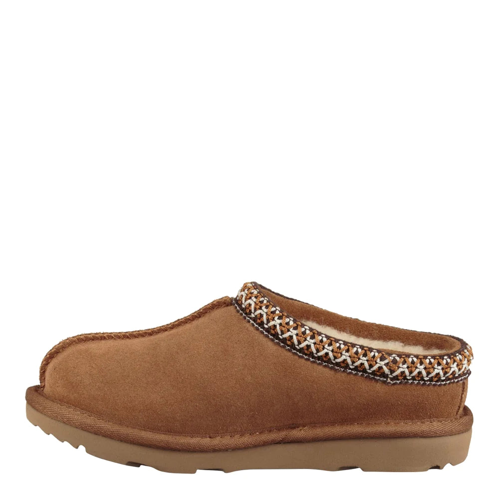 Side profile of a single UGG Kids Tasman slipper in chestnut. The shoe clearly shows the light brown suede material, the braided decorative trim around the opening, and the textured, low-profile rubber outsole.