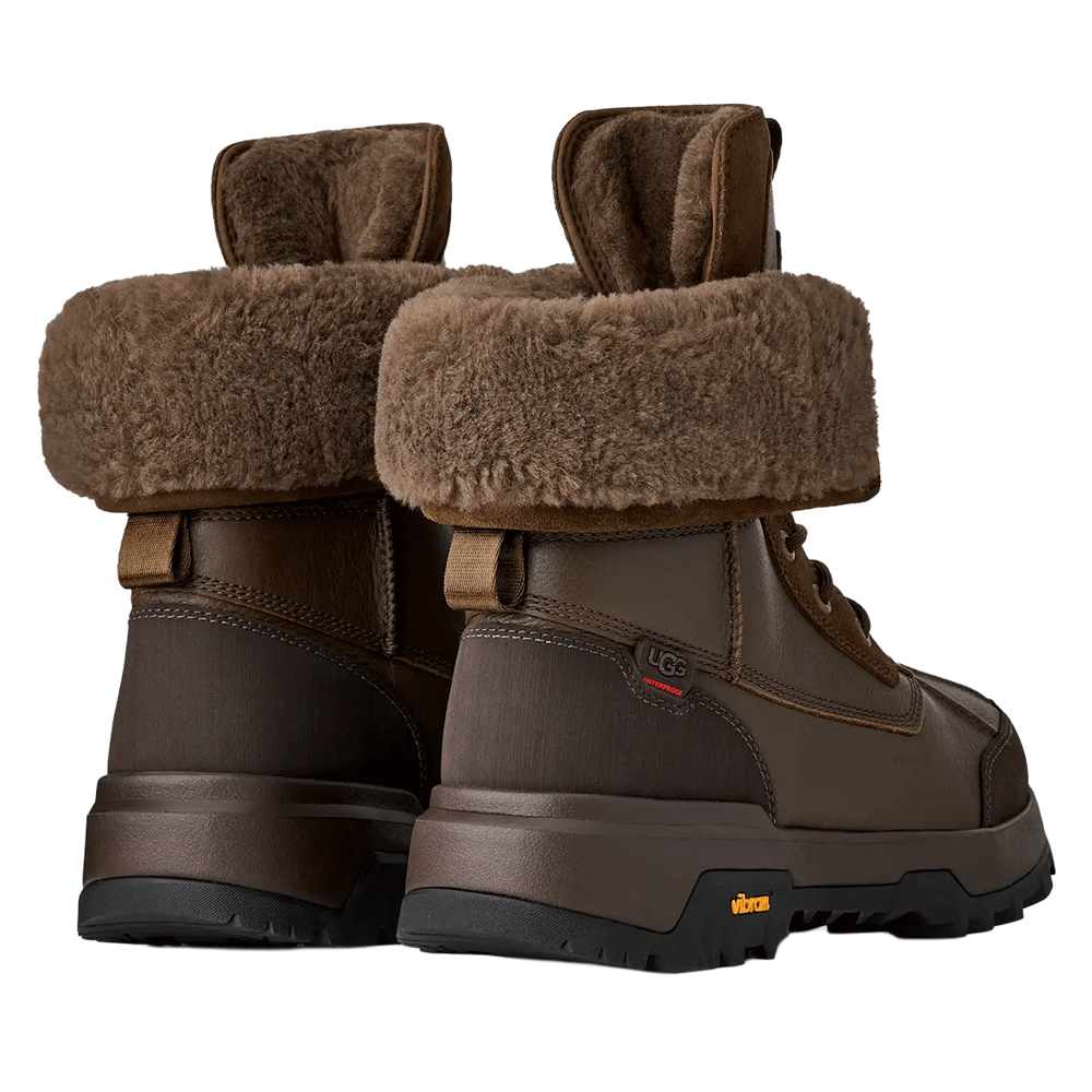 Rear view of a pair of Dark Toffee waterproof UGG boots, showing the fuzzy brown shearling cuffs, the dark brown leather and textile heel panels, and the Vibram sole.