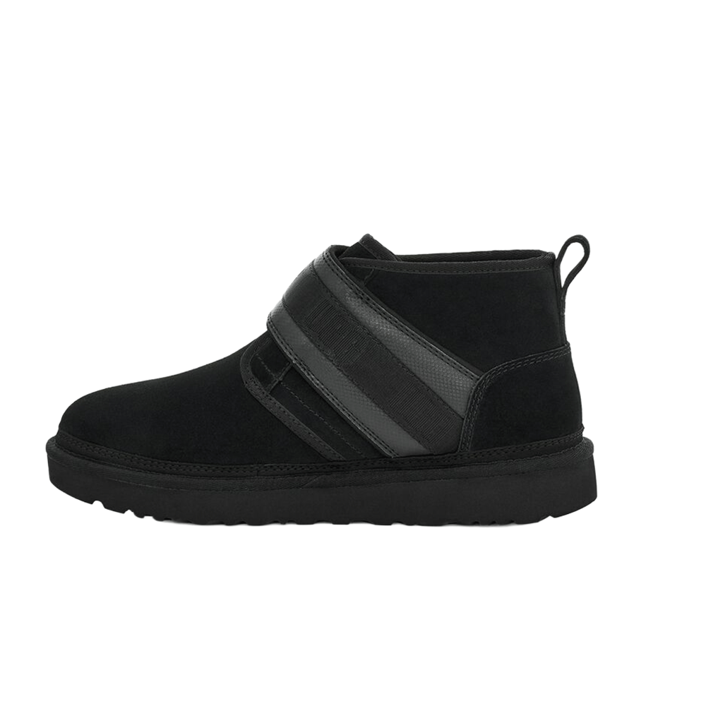 Side view of the black UGG Men's Neumel Snapback boot, highlighting the mid-cut suede upper, the contrasting synthetic fabric strap detail, and the convenient pull tab loop on the heel.