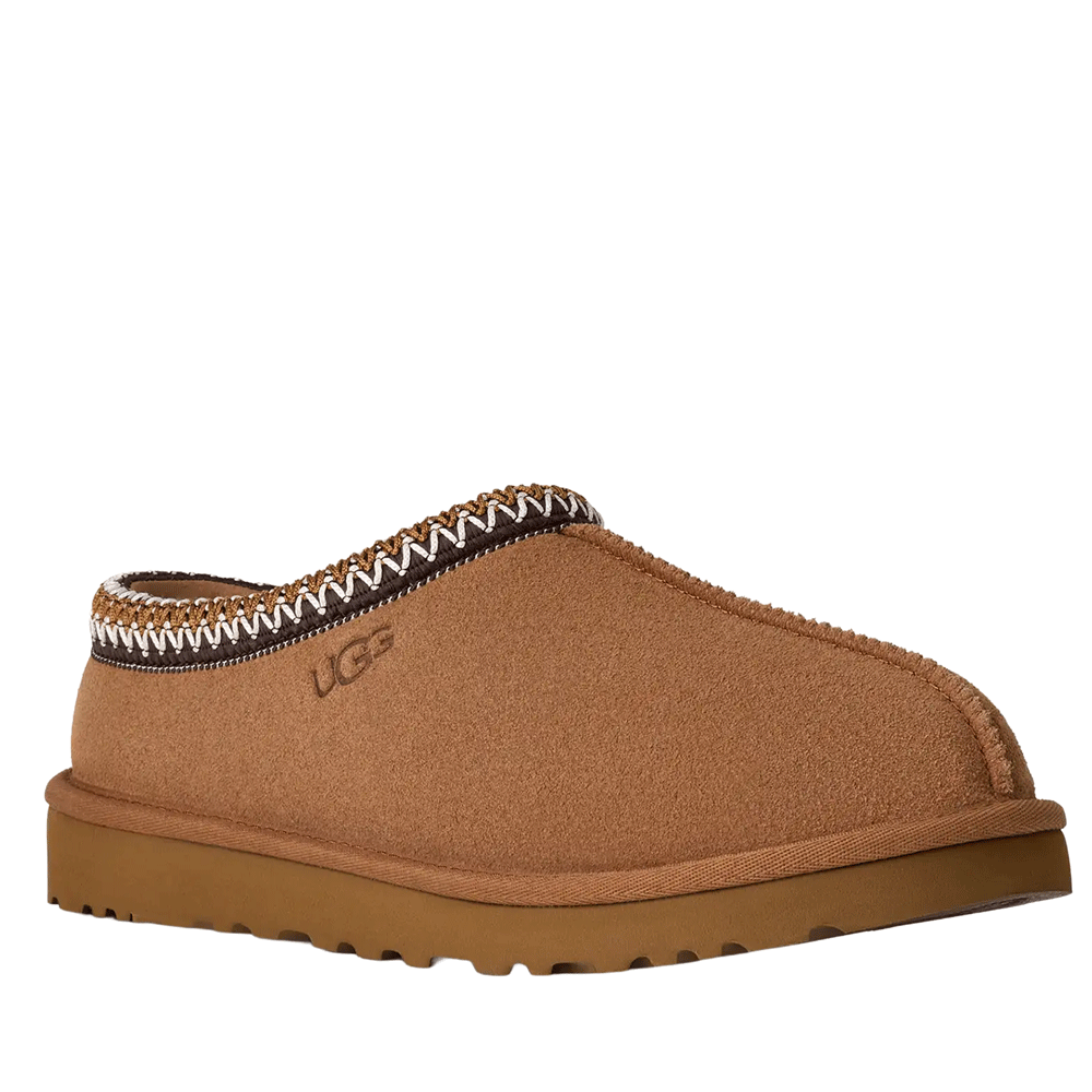 Side Angled of the UGG Men's Tasman slipper/shoe in chestnut suede, showing the low-cut opening, the multi-colored UGGbraid detail around the collar, and the durable, textured outsole.