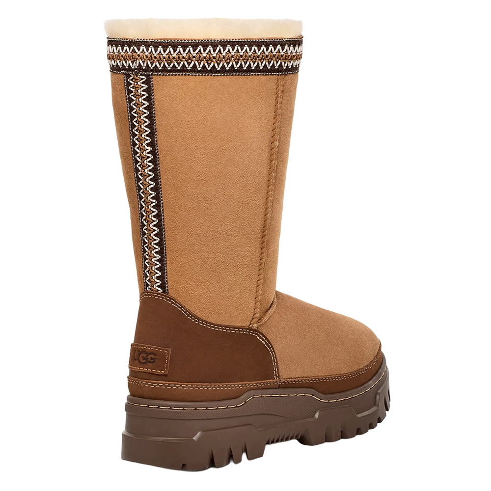 Rear view of the Chestnut UGG Classic Tall TrailGazer boot, highlighting the tall shaft's decorative side seam braiding, the embossed UGG logo on the dark brown leather heel counter, and the chunky brown platform sole.