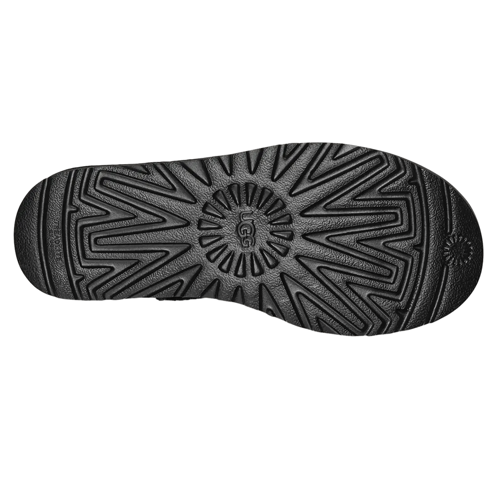 Bottom View of the black platform sole of the UGG Classic Boot, showing the deep Treadlite by UGG™ or Sugarcane EVA traction pattern and the central UGG logo.