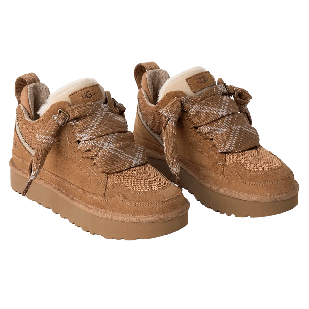 A pair of UGG Lowmel sneakers in a chestnut color, featuring the suede and mesh upper, prominent plaid-patterned laces, and the UGG logo patch on the tongue of each shoe.