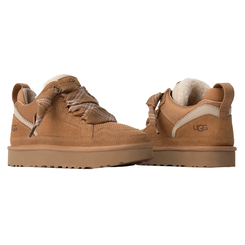 A pair of UGG Lowmel sneakers in a chestnut color, shown at a rear-side angle. The image emphasizes the visible UGGplush wool lining, the suede heel with the embossed UGG logo, and the wide plaid laces.