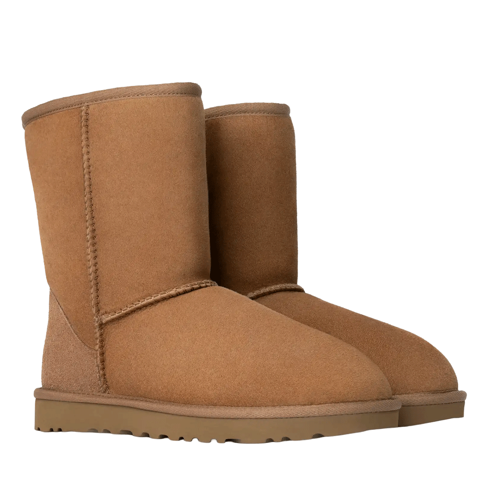 Front Side View of UGG Women's Classic Short II boots in the chestnut color, shown standing side-by-side and slightly angled to the right. The boots have a soft suede exterior, exposed seams, and a chunky brown sole.