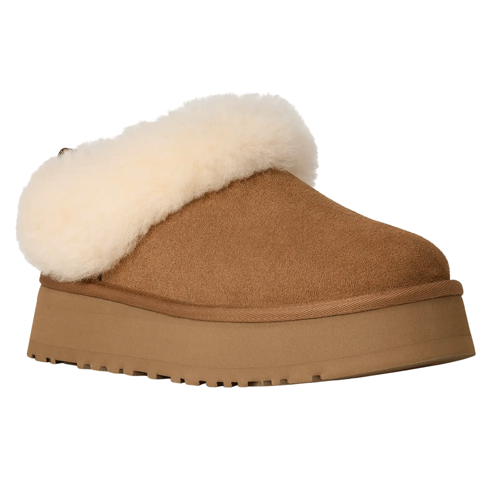 Angled front view of a single Tazzelle platform slipper in Chestnut suede. The slipper has a platform sole made with Sugarcane EVA and features a thick, fixed cuff of cream-colored sheepskin that wraps around the back.