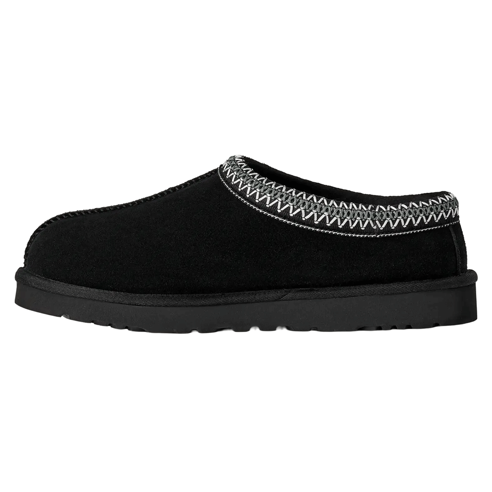 Side profile of the black UGG Tasman II slipper with a black suede upper and the signature gray and white UGGbraid trim around the collar. The sole is a thick, black Sugarcane EVA outsole.