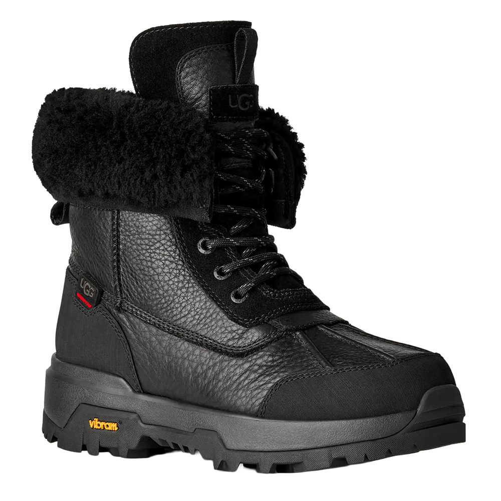 Front view of the Black UGG Adirondack Boot XXV, showcasing the waterproof pebbled leather upper, black fur cuff, lace-up front, and the durable Vibram outsole.