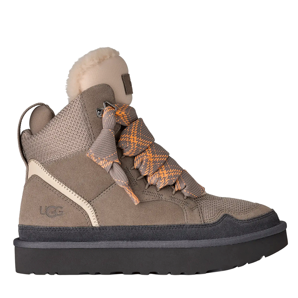 Side view of the Cobble Grey UGG Highmel high-top sneaker, featuring a suede and recycled canvas mesh upper, large orange and gray patterned laces, a plush-lined padded collar, and a thick gray Sugarcane EVA platform outsole.