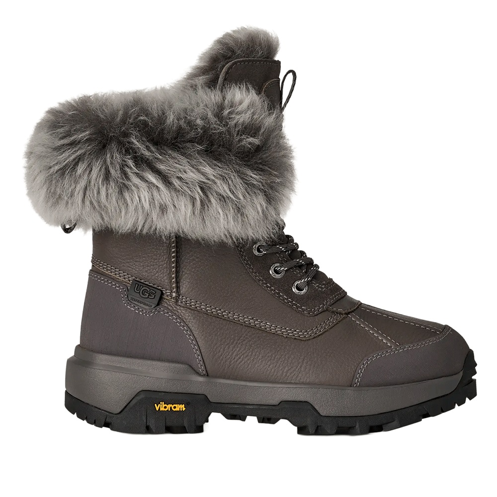UGG waterproof women's or adult's winter boot in charcoal gray leather with a thick, fluffy gray faux fur collar and a black Vibram traction outsole.