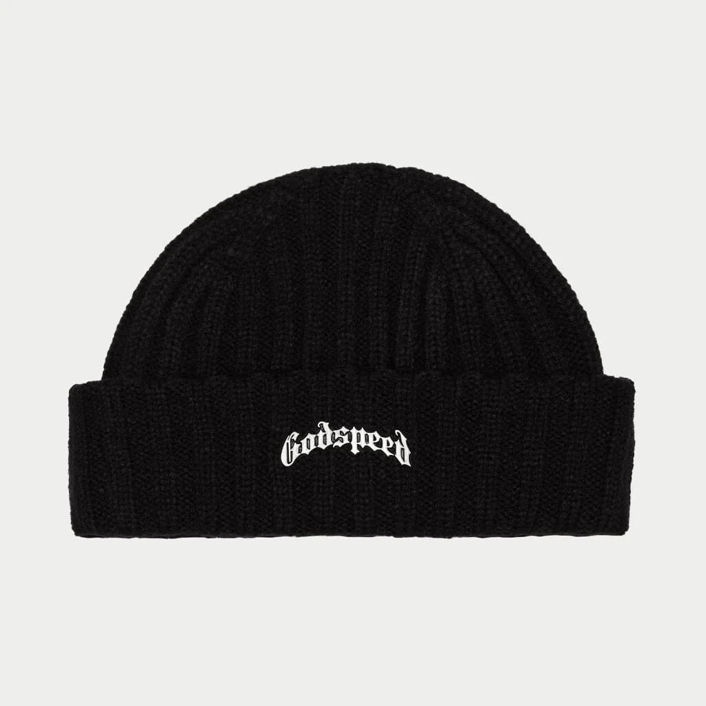 A black ribbed beanie with a white embroidered "Godspeed" logo in a stylish, gothic-inspired font on the folded cuff. The comfortable beanie is shown against a neutral background.