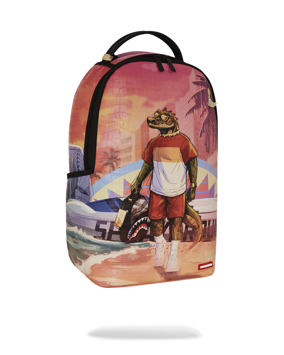 A black Sprayground backpack featuring a graphic of a cool, anthropomorphic alligator standing on a beach. The alligator is wearing a striped white and red shirt, red shorts, and sunglasses. He is holding a Sprayground backpack in one hand. In the background, a sunset with palm trees and a city skyline are visible, along with a surf van with a shark mouth design. The entire backpack has a subtle, crocodile-skin texture. The bottom of the bag has a small red tag with the Sprayground logo.
