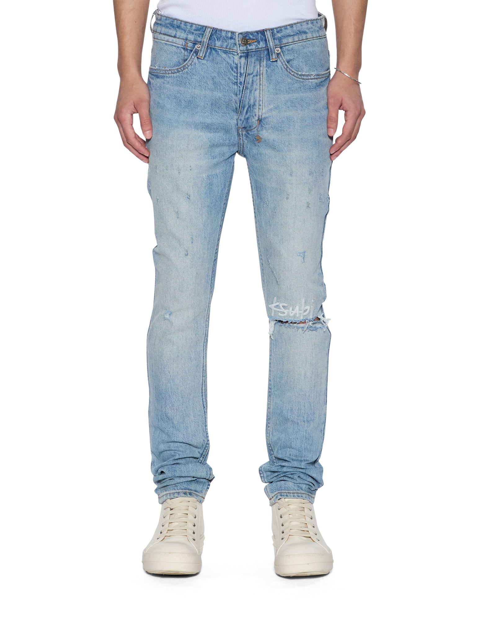 Light blue distressed jeans worn by a person on a white background