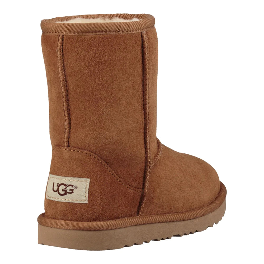 Rear view of UGG Kid's Classic II boot in chestnut. The image prominently features the tall shaft, the white UGG logo patch on the heel, and a view of the plush lining at the cuff.