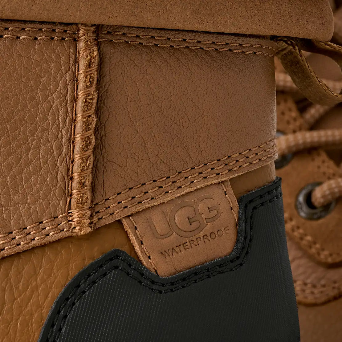 Close-up of a UGG boot with a visible brand logo and waterproof label.