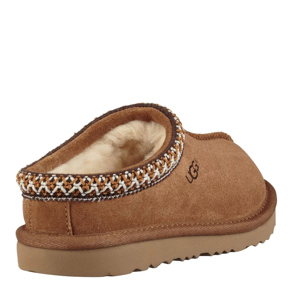 Rear three-quarter view of a single UGG Kids Tasman slipper in chestnut. The image clearly shows the heel area, the decorative braided Tasman trim around the collar, and the visible white wool lining.
