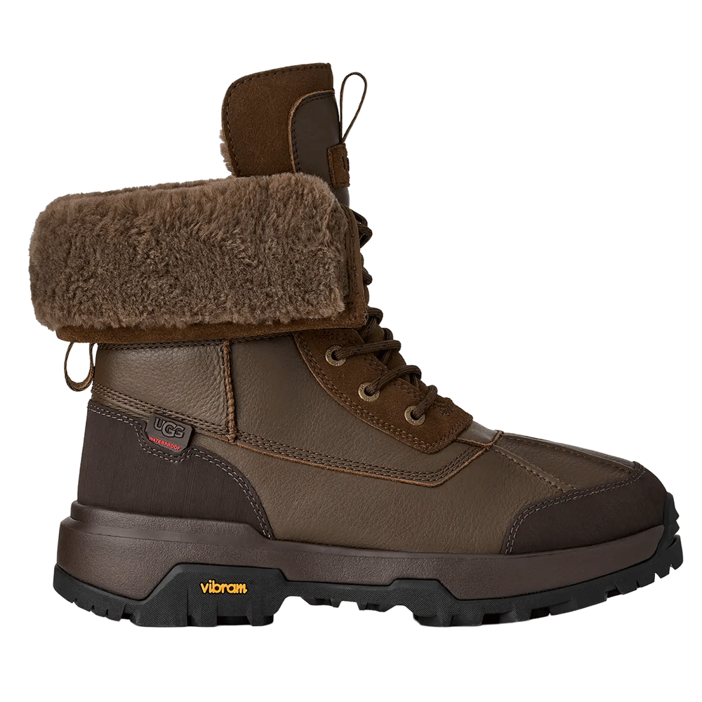 Dark Toffee waterproof UGG leather boot with a fuzzy brown shearling cuff, matching laces, and a rugged dark brown and black Vibram sole.