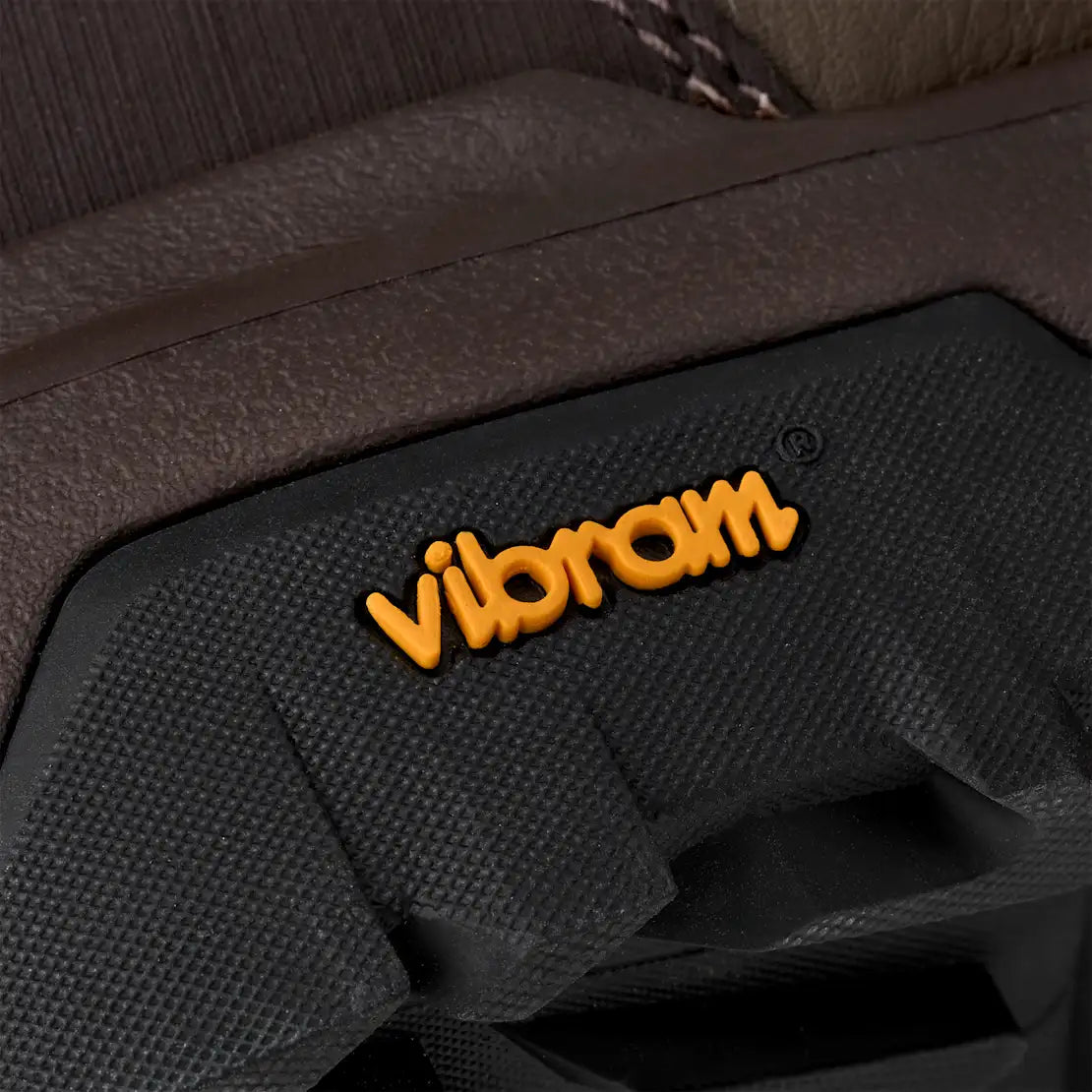 Close-up of a Vibram logo on a textured surface