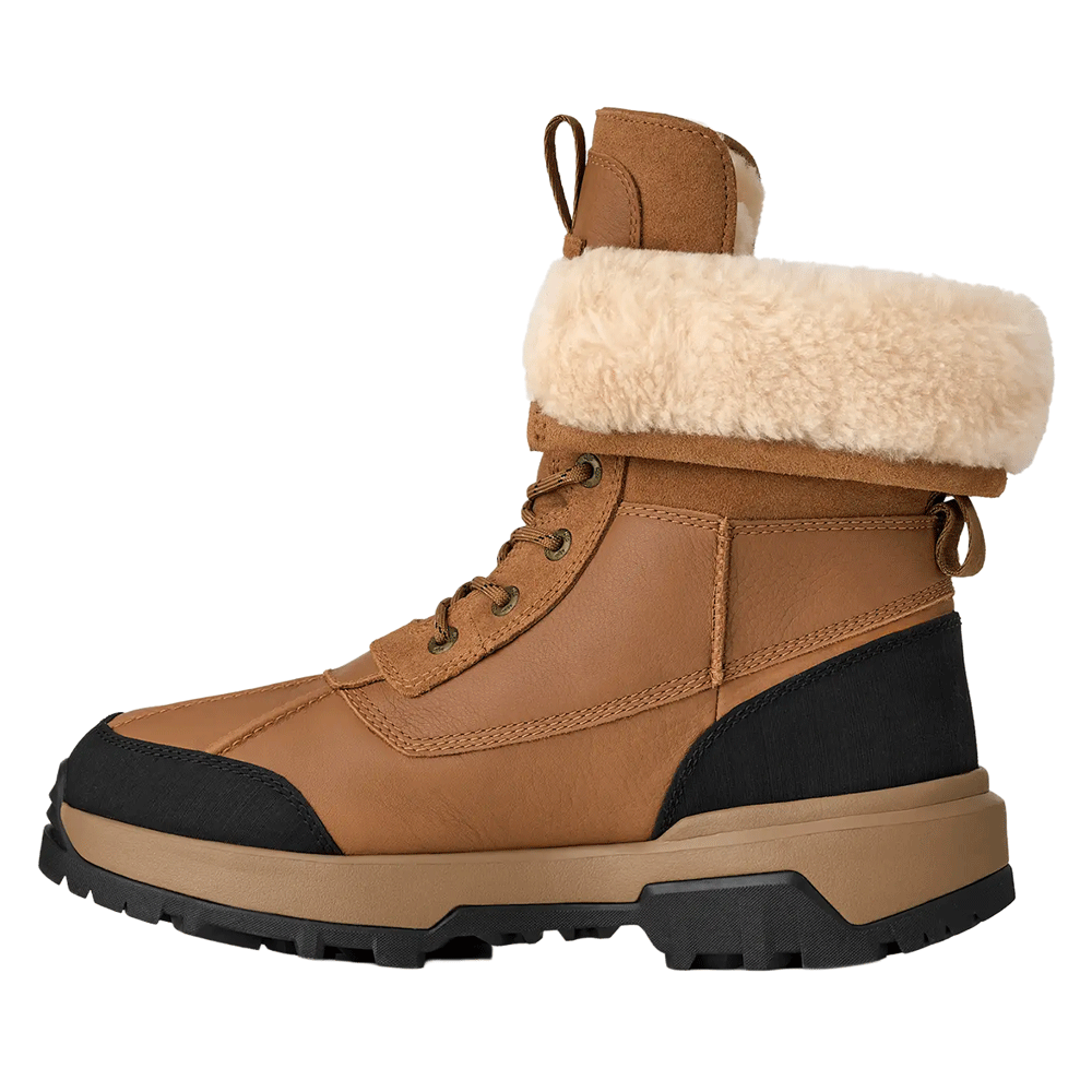 Side profile of the Chestnut waterproof UGG leather boot featuring a cream shearling cuff, brown laces, and a sturdy brown and black sole.