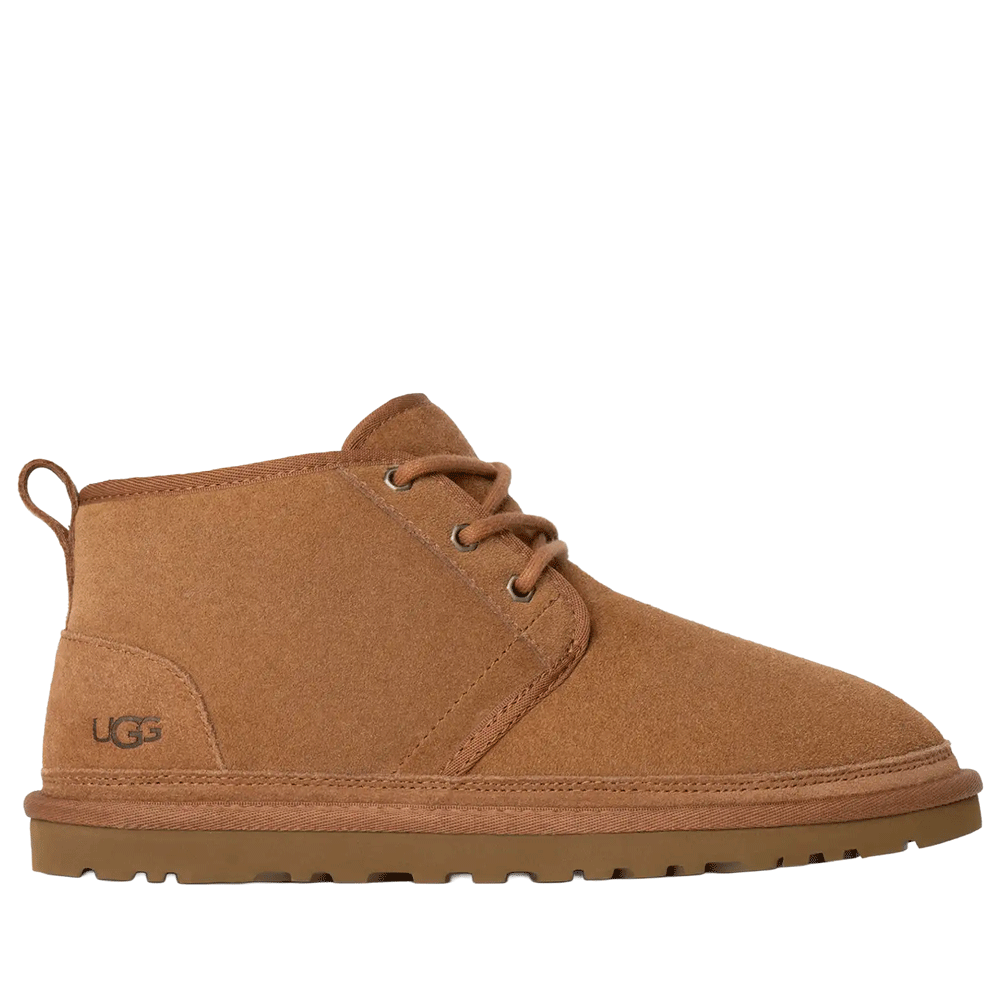 Side view of the UGG Men's Neumel chukka boot in classic chestnut suede. The boot has a lace-up front with two silver metal eyelets, a comfortable low shaft, a subtle embossed UGG logo on the heel, and a matching thick, textured outsole.