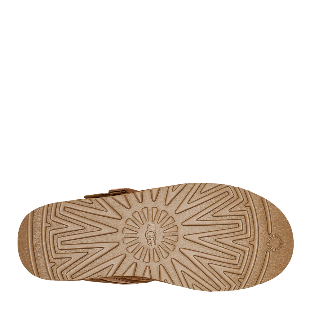 Bottom view of the chestnut-colored sole of the UGG Men's Neumel Snapback boot, showing the repeating starburst traction pattern and the circular UGG logo tread design.