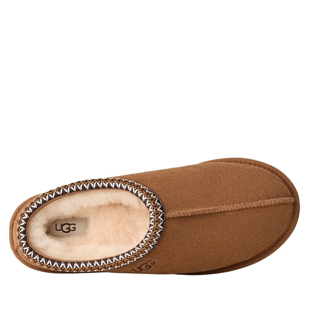 Top-down view of the chestnut UGG Men's Tasman slipper, showing the suede toe area, the plush cream-colored interior lining, and the distinctive multi-colored UGGbraid detail around the collar.