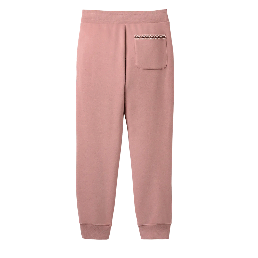 Rear view of dusty rose UGG sweatpants with a single back patch pocket detailed with braided trim.