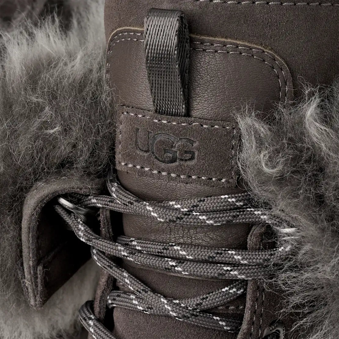 Close-up of a UGG boot with fur lining and visible brand logo.