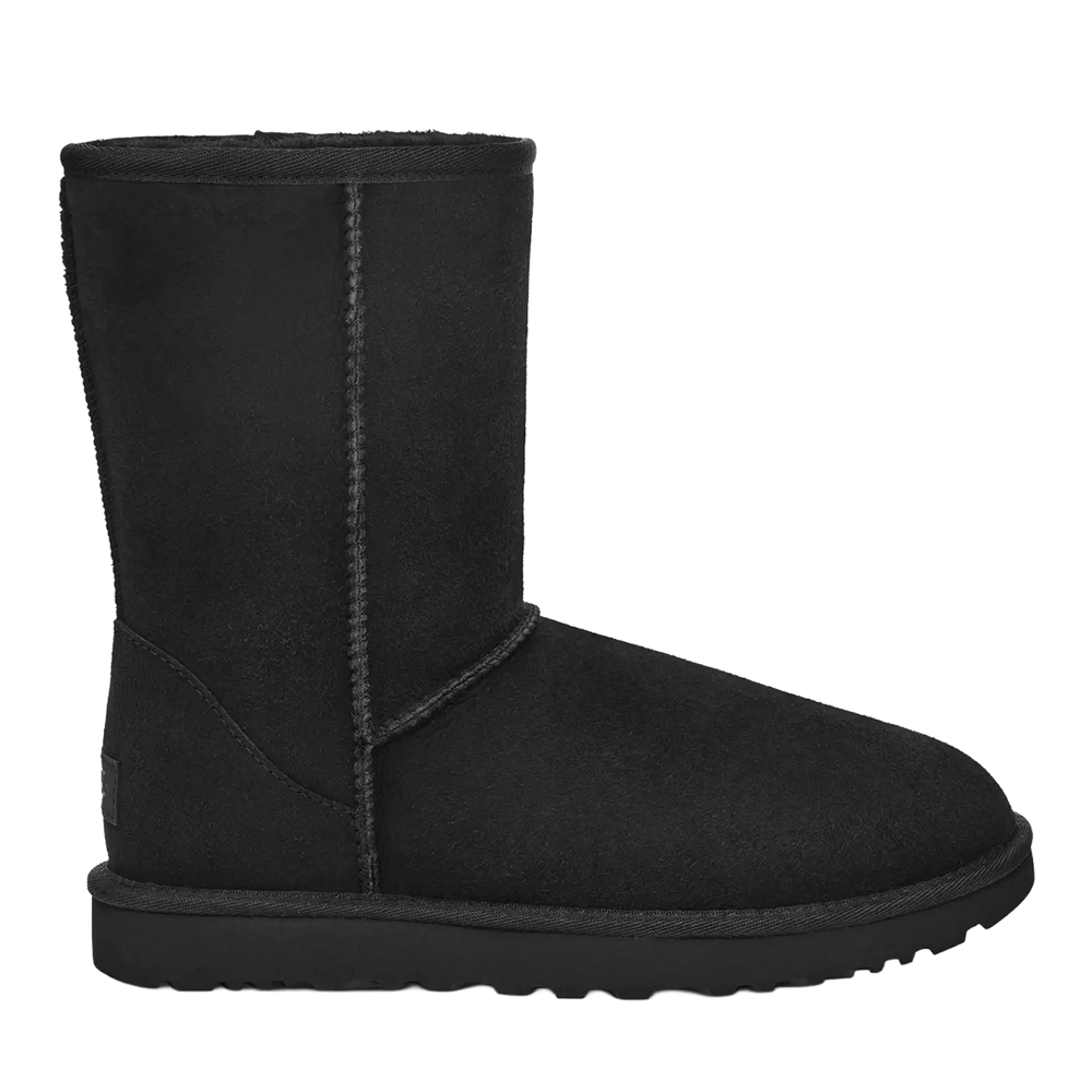 Side view of the black UGG Women's Classic Short II boot, highlighting the water-resistant suede upper, the round toe shape, and the signature stitched seams running up the shaft.