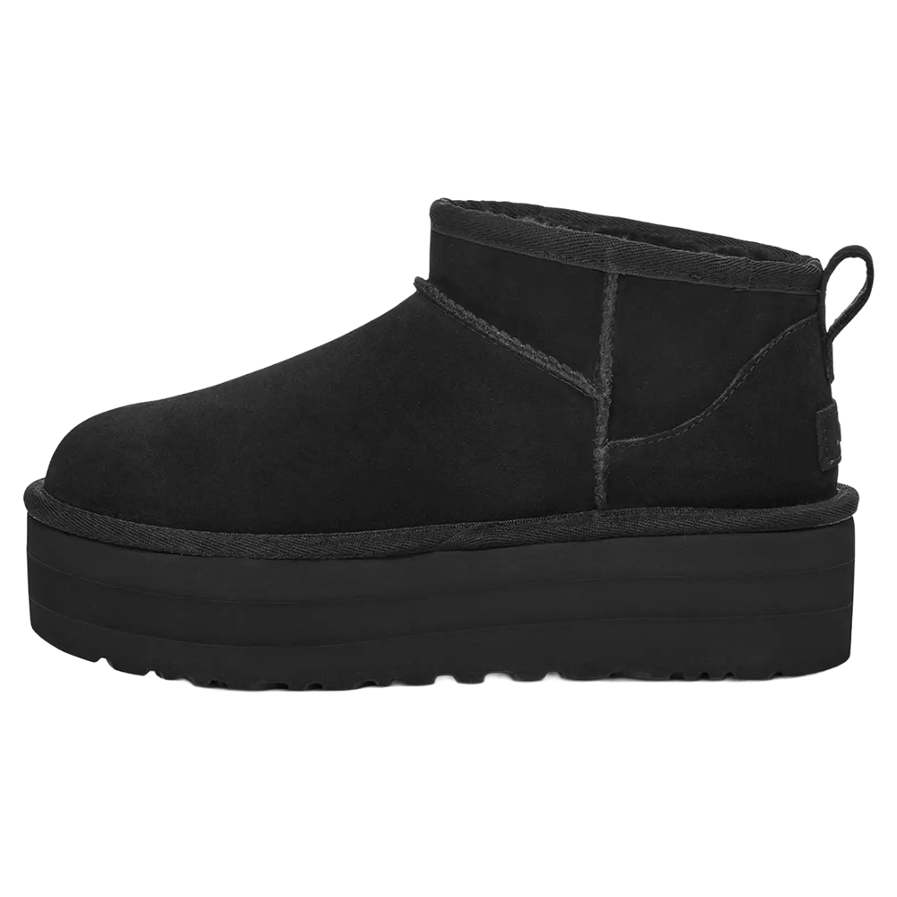Side View Of Black suede UGG Classic Boot Ultra Mini Platform with thick elevated sole, overlock stitching, and asymmetrical topline