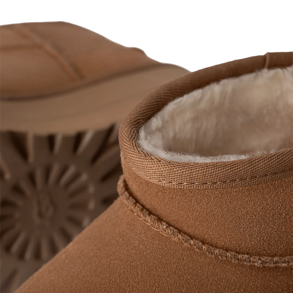 Extreme close-up of a Chestnut UGG boot, highlighting the soft UGGplush lining and the Sugarcane EVA Treadlite sole texture in the background.