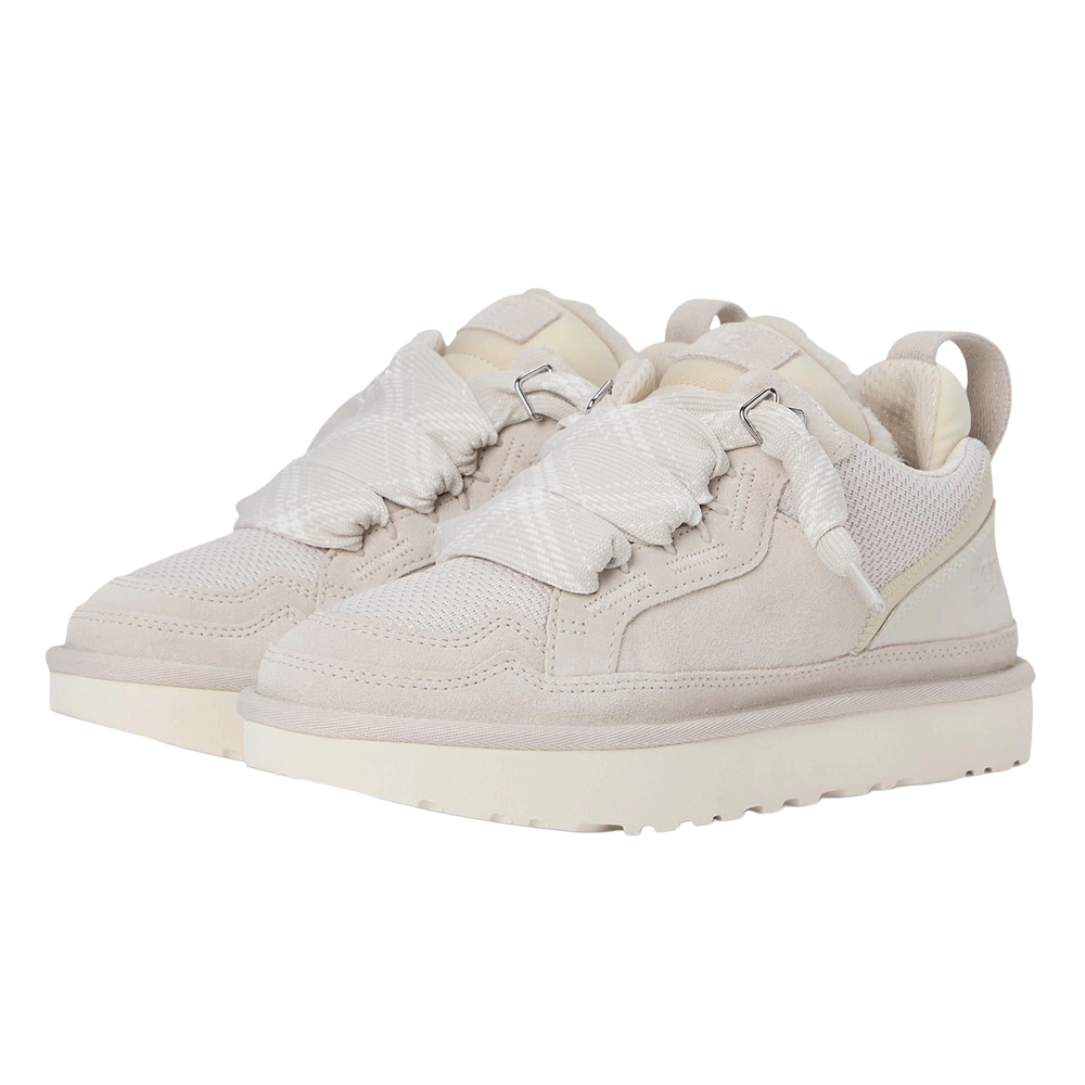 A front-angle view of a pair of UGG Lowmel sneakers in a light, neutral color, highlighting the wide, plaid-patterned fabric detail over the vamp and the thick, contrasting white outsole.