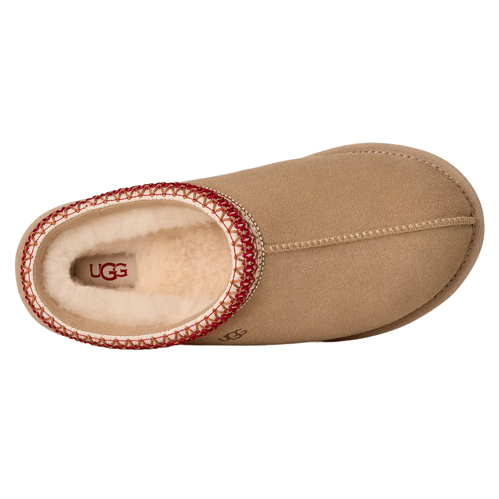 Top-down view of the Sand UGG Tasman II slipper, showcasing the suede upper, the exposed seam stitching down the center, the prominent red and white UGGbraid trim around the collar, and the visible plush sheepskin interior with the UGG logo on the insole.