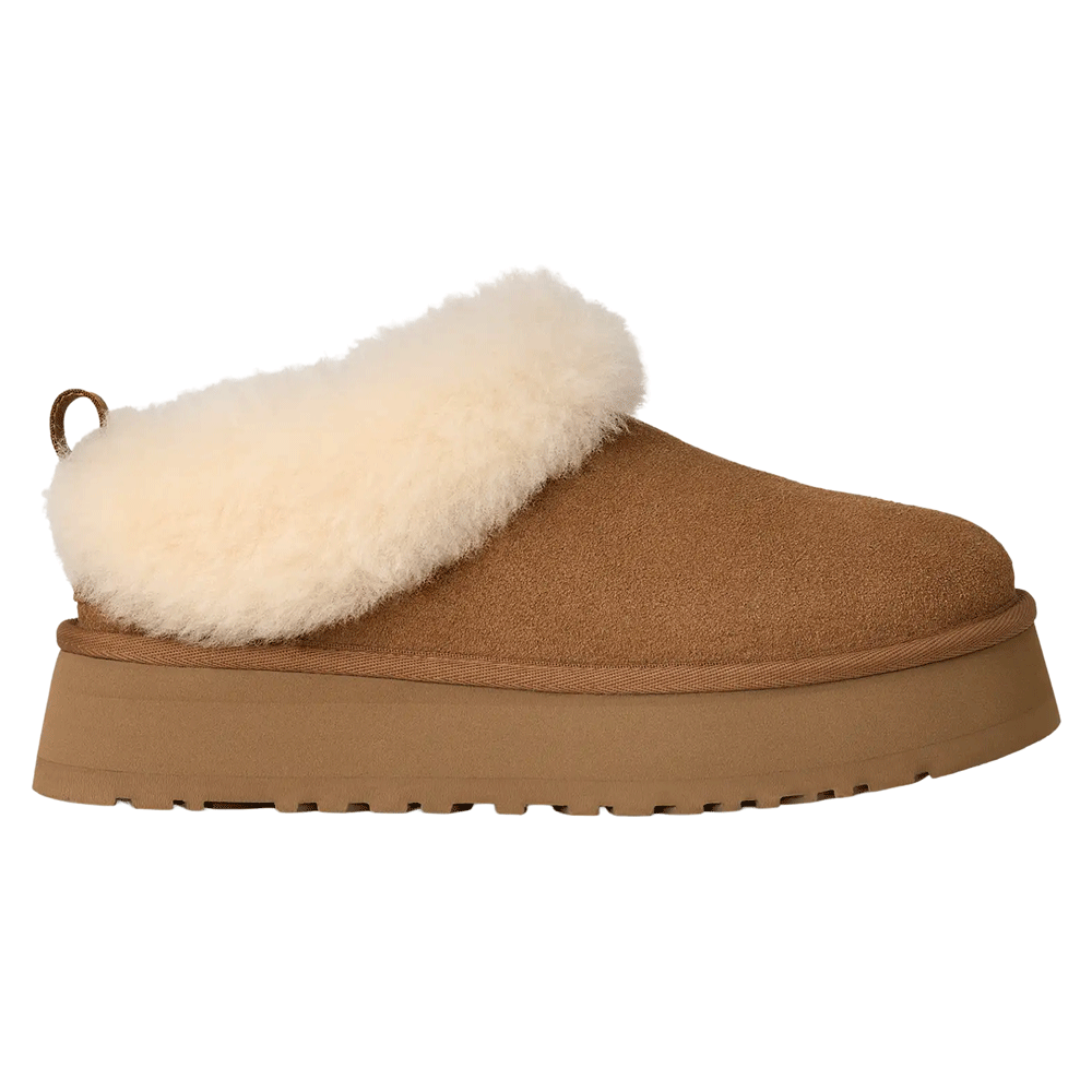 Side profile of a single Chestnut UGG Tazzelle indoor-outdoor slipper. The genuine suede upper is complemented by a lush, cream-colored sheepskin collar and lining, and sits atop  lightweight platform sole made from sugarcane EVA.