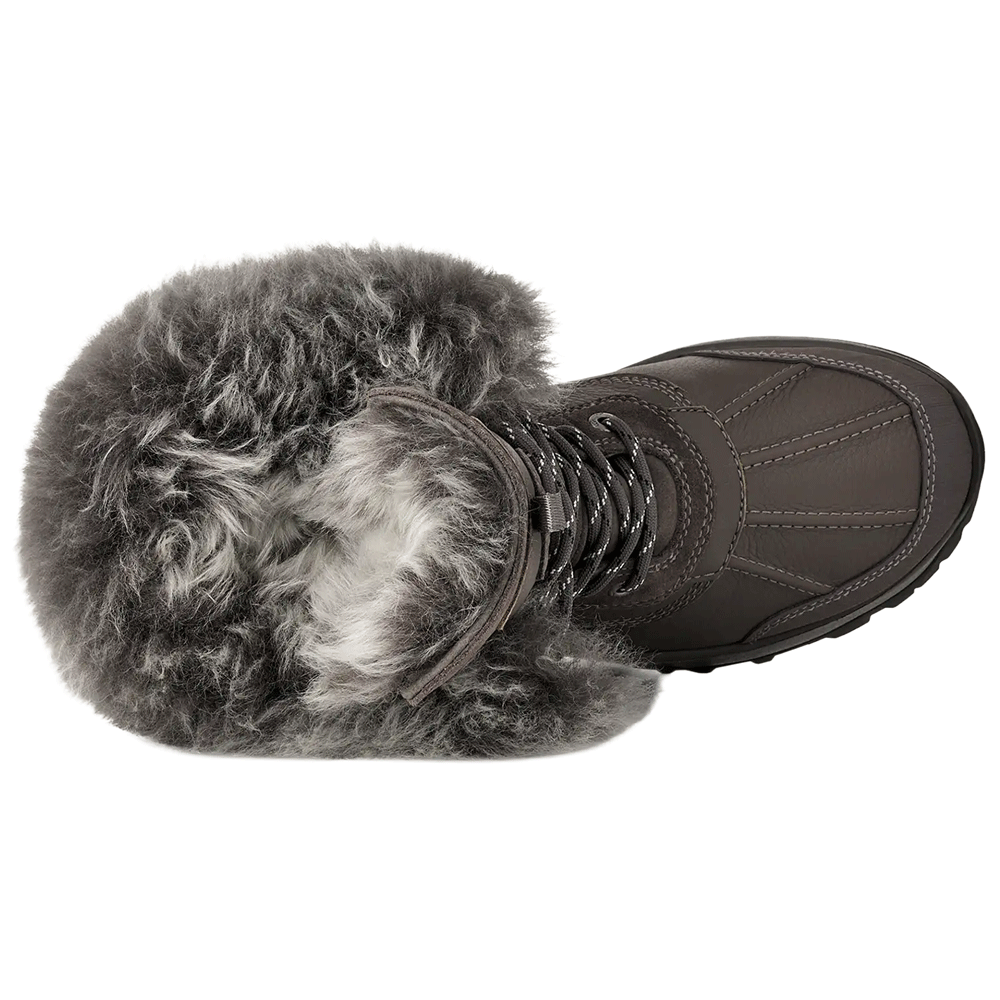 Top-down view of the grey UGG winter boot, clearly showing the full, dense grey fur lining the opening, the speckled laces, and the stitched toe area of the boot.