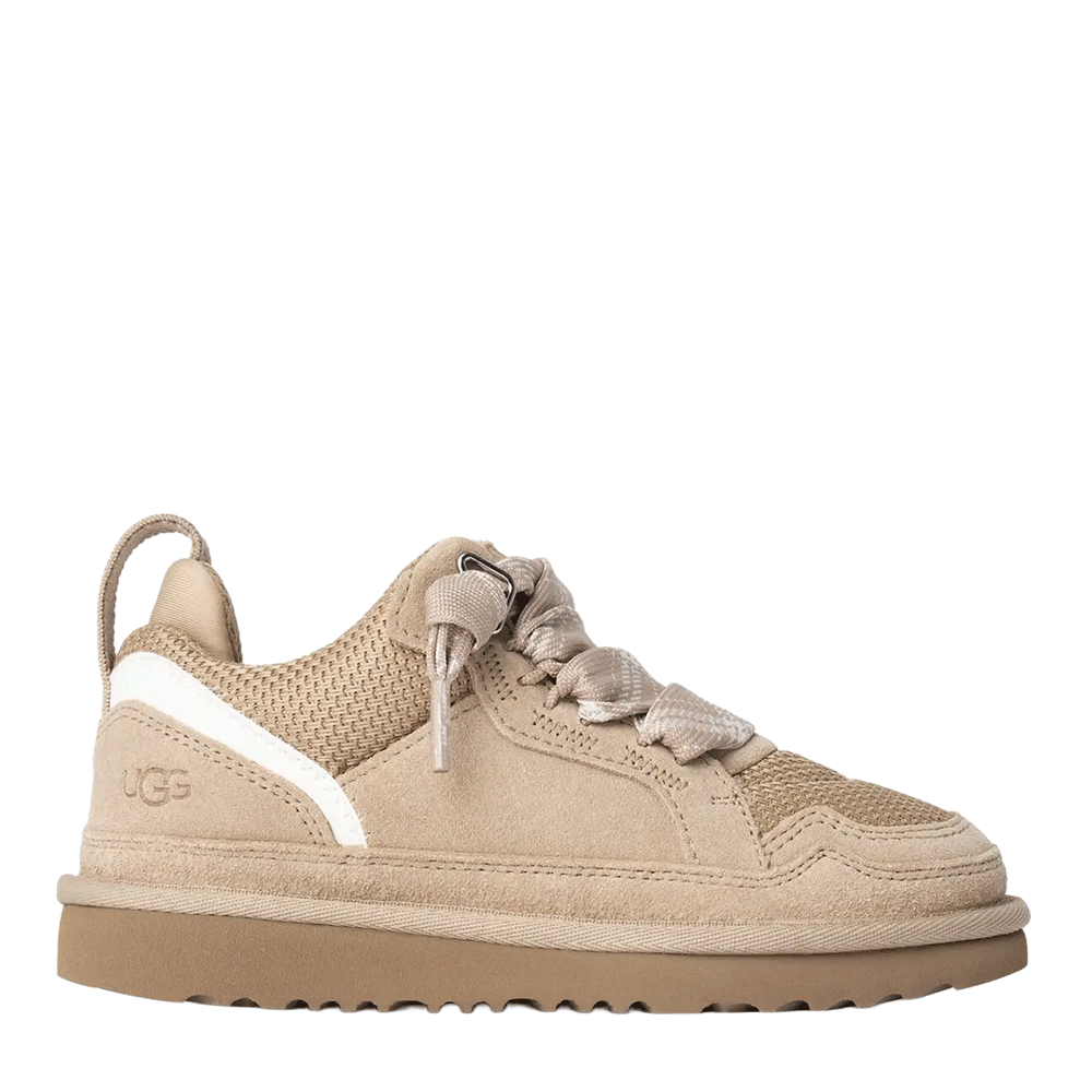 Side view of the Sand UGG Lowmel low-top sneaker, featuring a suede and textile mesh upper, light patterned laces tied loosely, a subtle white stripe accent on the heel, and a textured Sugarcane EVA outsole.