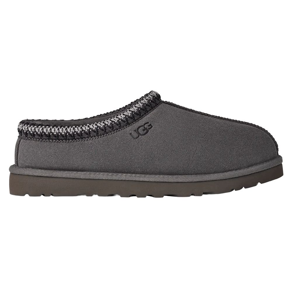 Side view of the dark gray UGG Tasman II slipper with suede upper, gray and white UGGbraid trim, and a dark gray Sugarcane EVA outsole.