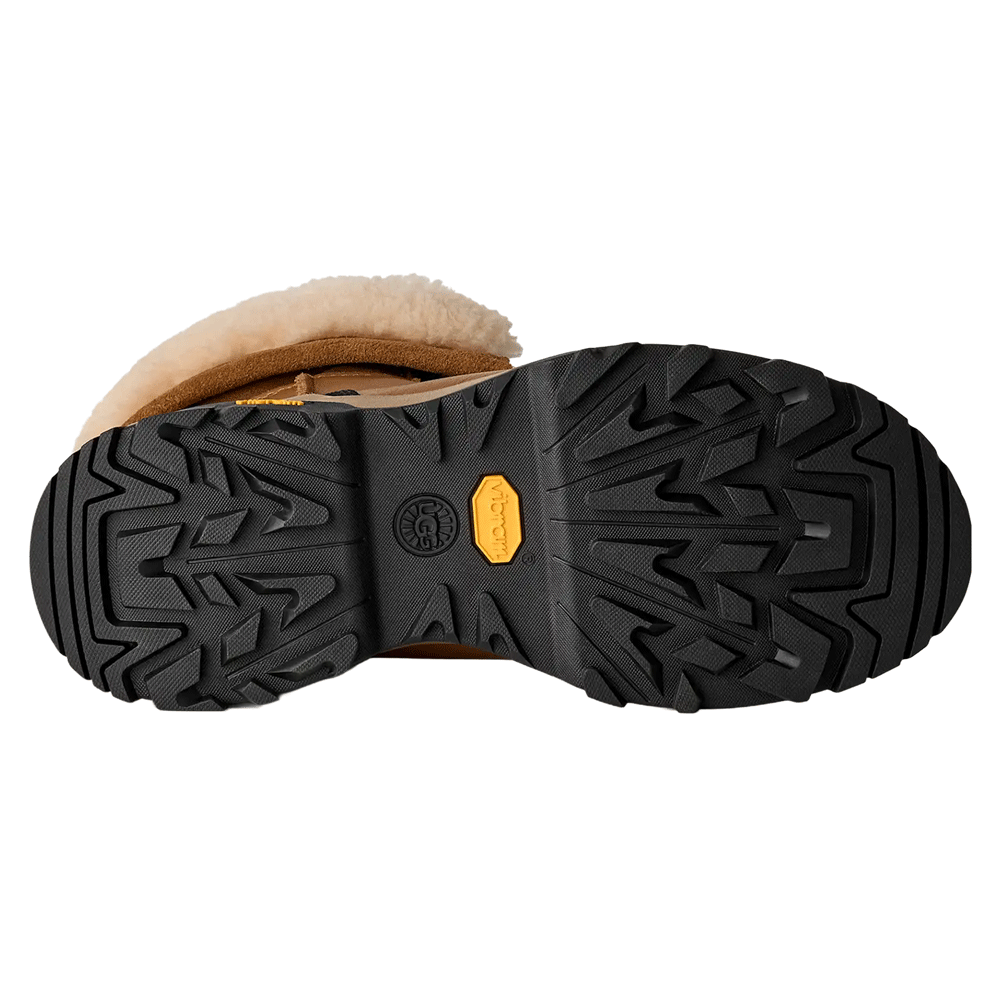 Bottom view of the Chestnut UGG Adirondack Boot XXV, showcasing the heavy-duty black Vibram ICETREK outsole with aggressive multi-directional treads and a prominent yellow Vibram logo.