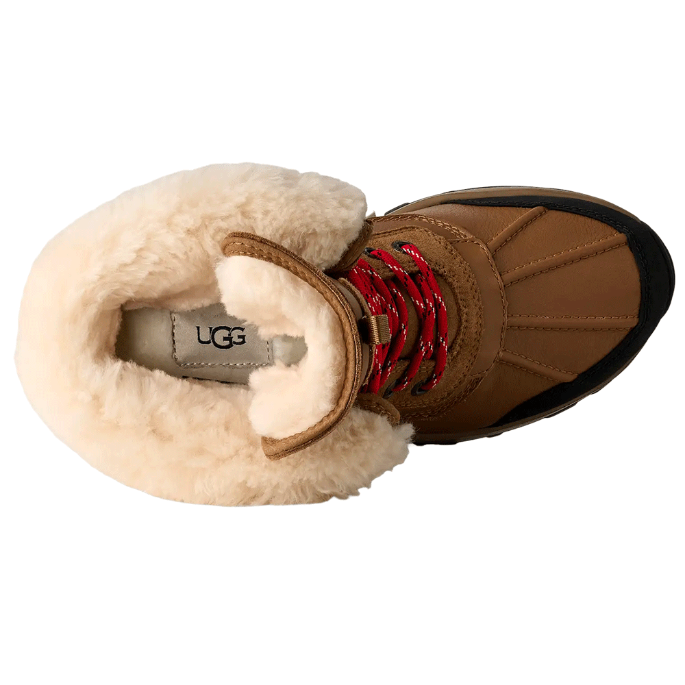 Top-down view of the Chestnut UGG Adirondack Boot XXV, showcasing the wide, plush cream-colored shearling lining, the red speckled laces, and the UGG logo on the footbed.