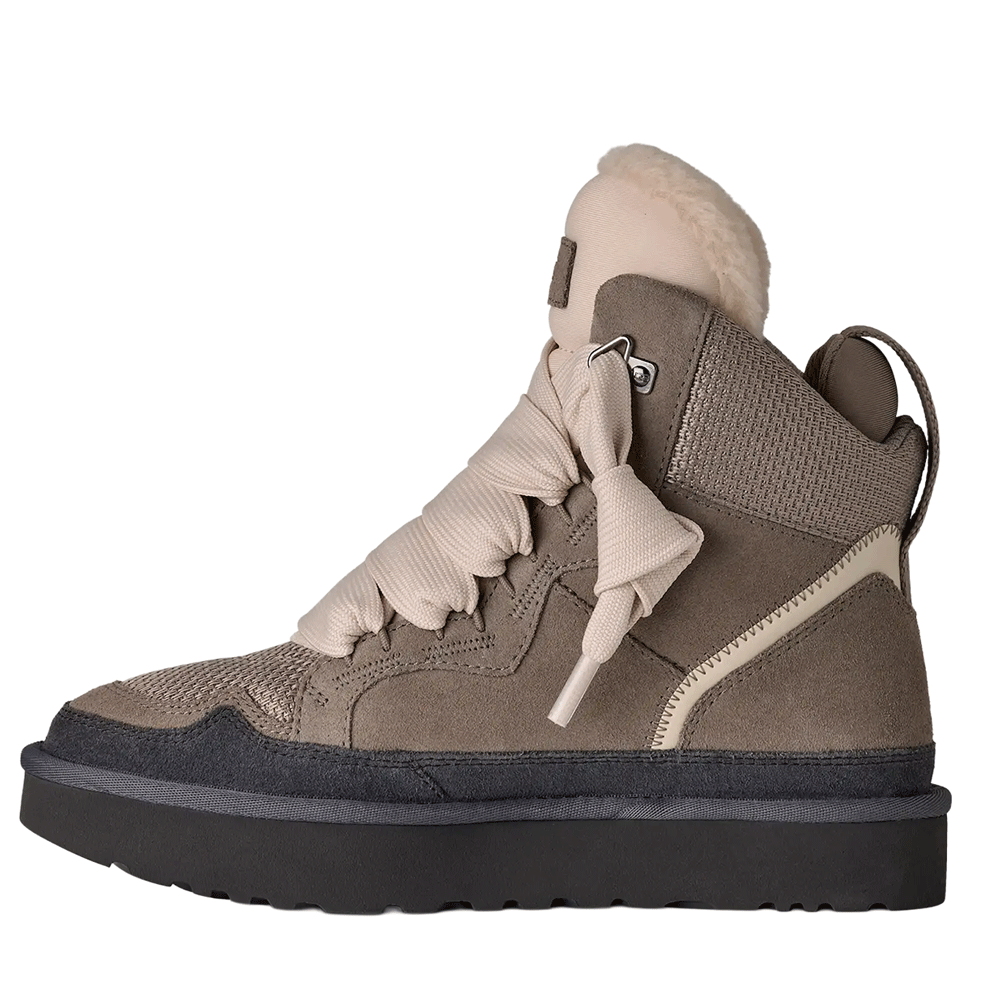 Side view of the Cobble Grey UGG Highmel high-top sneaker, featuring a suede and recycled canvas mesh upper, solid light beige laces, a plush-lined padded collar, and a thick gray Sugarcane EVA platform outsole.