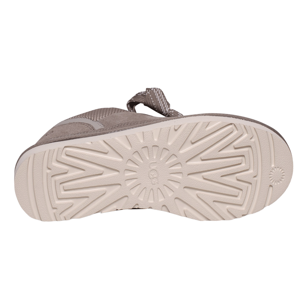 View of the outsole (bottom) of the UGG Lowmel sneaker in Smoke Plume. The thick, off-white Sugarcane EVA sole features a molded tread pattern with the circular UGG logo at the center.