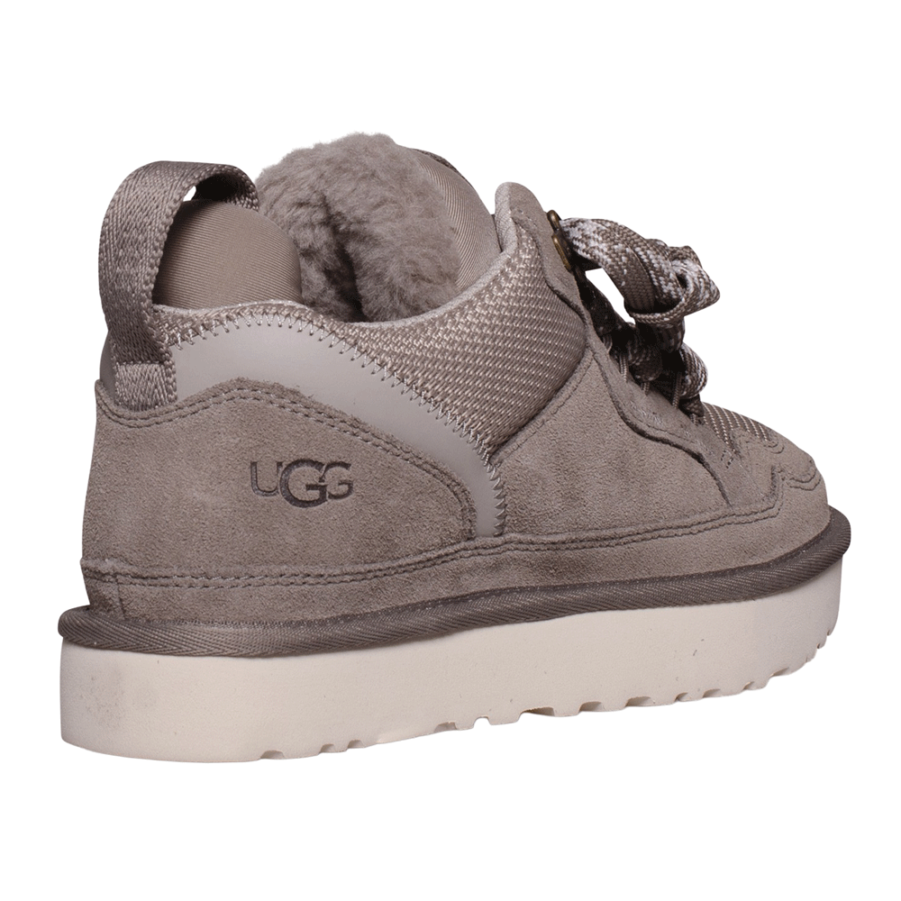 Rear view of the UGG Lowmel sneaker in Smoke Plume. Features include the UGG logo embossed on the suede heel panel, a webbing pull strap, and visible UGGplush lining around the collar above the thick, off-white sole.