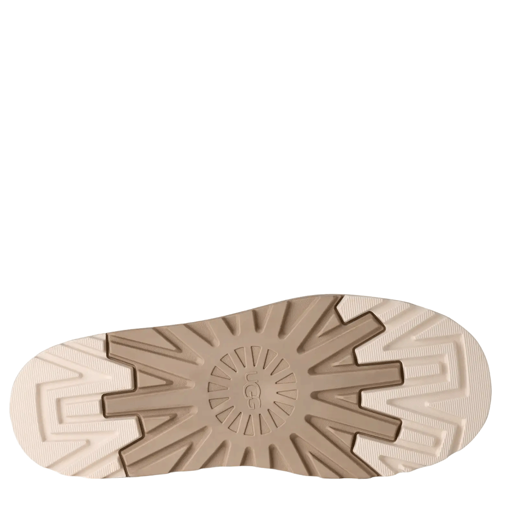 Bottom view of the Chestnut Tasman StreetScape mule, showcasing the lugged, light beige platform outsole with large segmented treads and a prominent circular UGG logo detail.