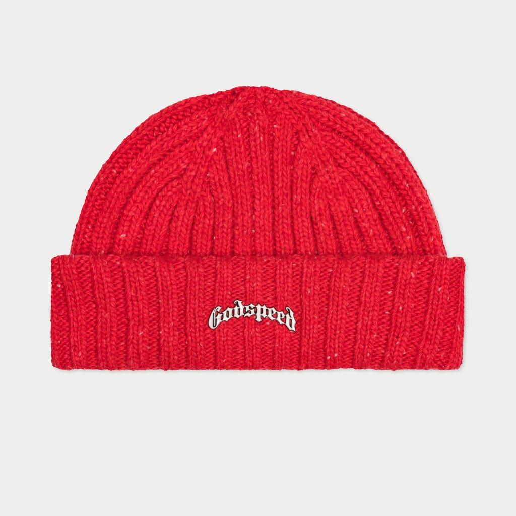 A vibrant red beanie with a ribbed knit pattern and white speckles, featuring an embroidered "Godspeed" logo in a stylized, black and white gothic font on the folded cuff.